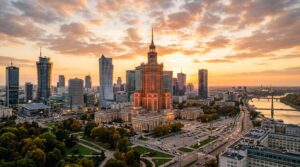 A professional wide-angle cityscape photograph of Warsaw’s skyline at golden hour, featuring the Pal