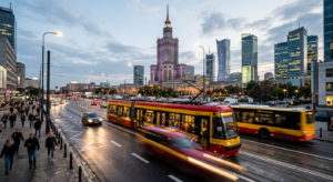 A high-quality, editorial-style photograph depicting a modern Warsaw cityscape with a blurred motion